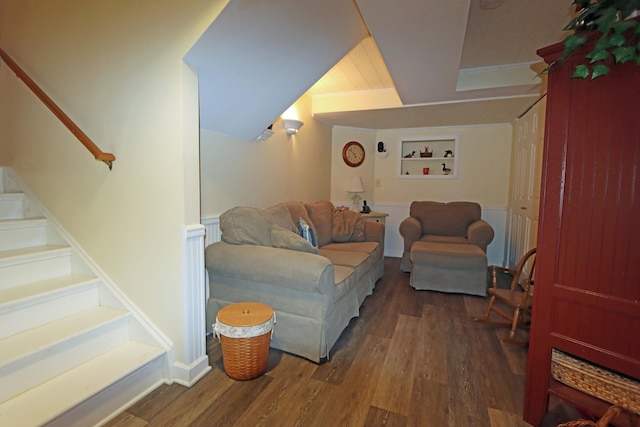 living area with stairway and wood finished floors