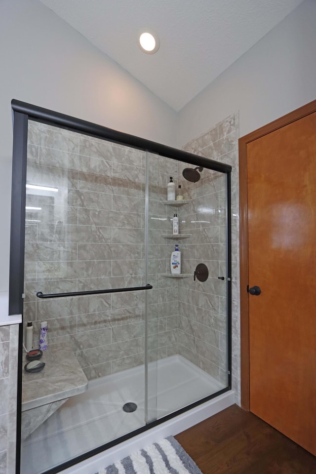 bathroom featuring a stall shower and wood finished floors