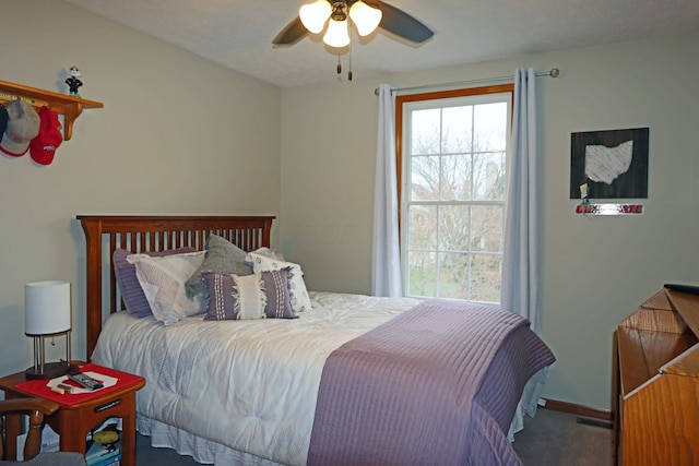 bedroom with baseboards, visible vents, carpet floors, and ceiling fan