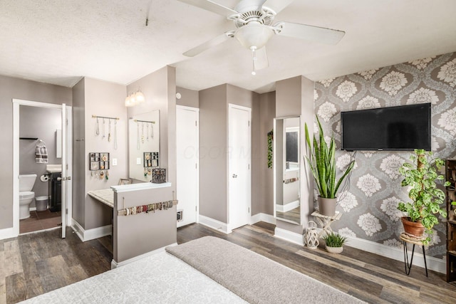 500 Foxtrail Cir E, Westerville, OH 43081 - bedroom with ensuite bathroom, baseboards, dark wood finished floors, and an accent wall