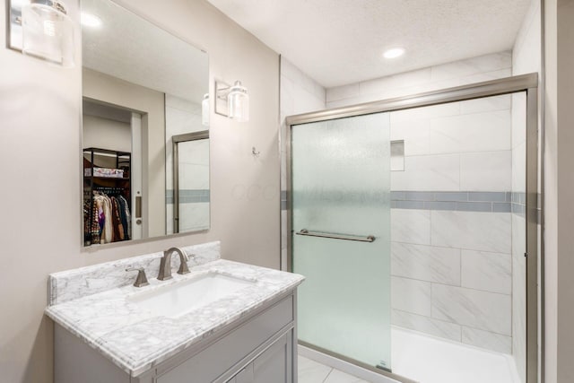 500 Foxtrail Cir E, Westerville, OH 43081 - full bath featuring a spacious closet, a shower stall, a textured ceiling, and vanity