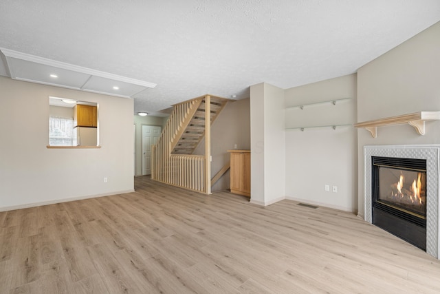 692 Parkbluff Way, Lewis Center, OH 43035 - unfurnished living room featuring recessed lighting, light wood finished floors, a fireplace, and stairs
