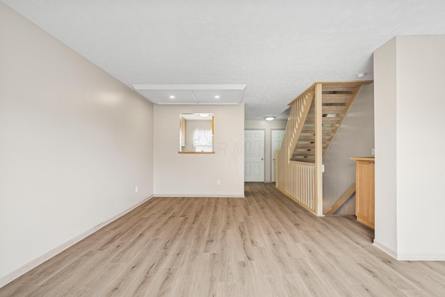 692 Parkbluff Way, Lewis Center, OH 43035 - unfurnished living room featuring light wood-style floors, a textured ceiling, recessed lighting, and stairway