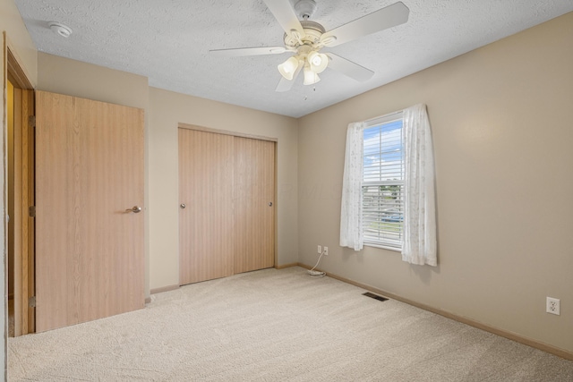 692 Parkbluff Way, Lewis Center, OH 43035 - unfurnished bedroom with carpet flooring, a closet, a textured ceiling, and a ceiling fan