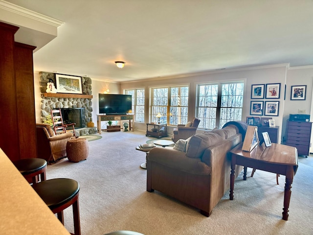 living room with carpet floors, a stone fireplace, and ornamental molding