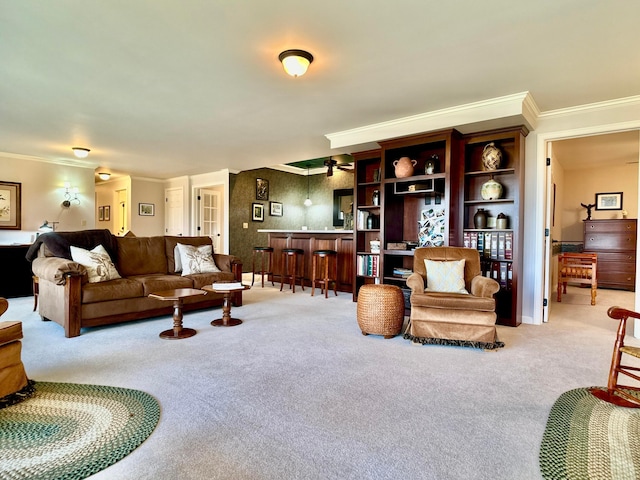 living area featuring ornamental molding and carpet flooring