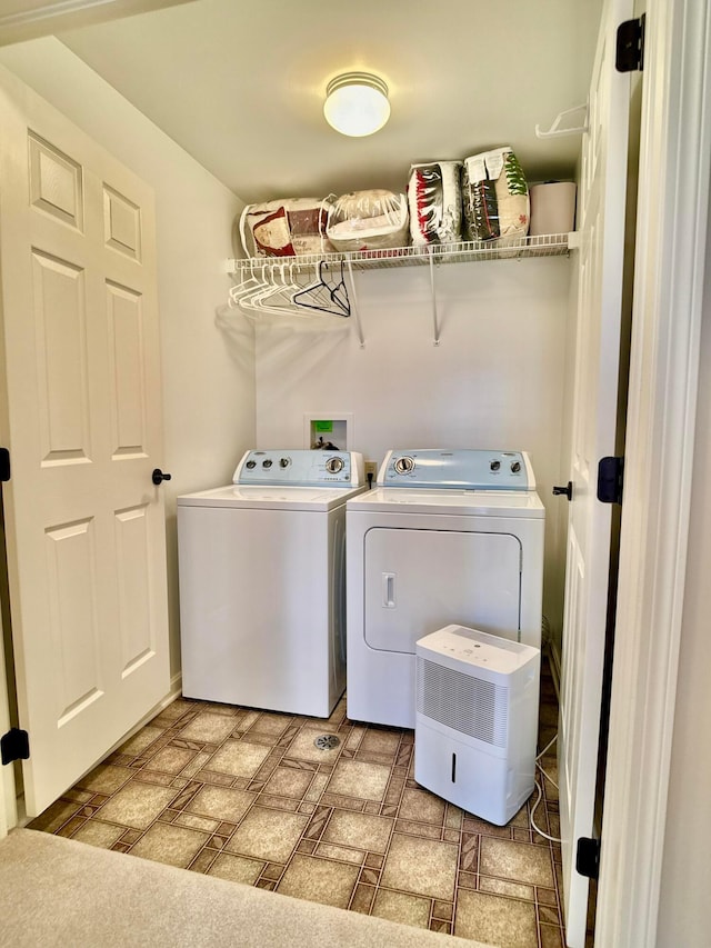 clothes washing area with washer and dryer and laundry area