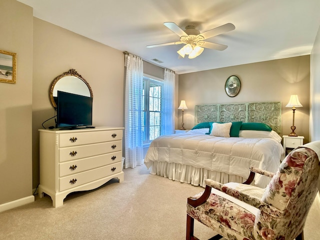 bedroom featuring visible vents, baseboards, light colored carpet, and ceiling fan