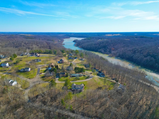 bird's eye view featuring a wooded view and a water view