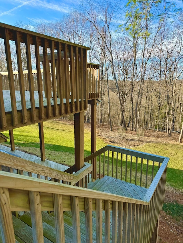 wooden terrace featuring a yard