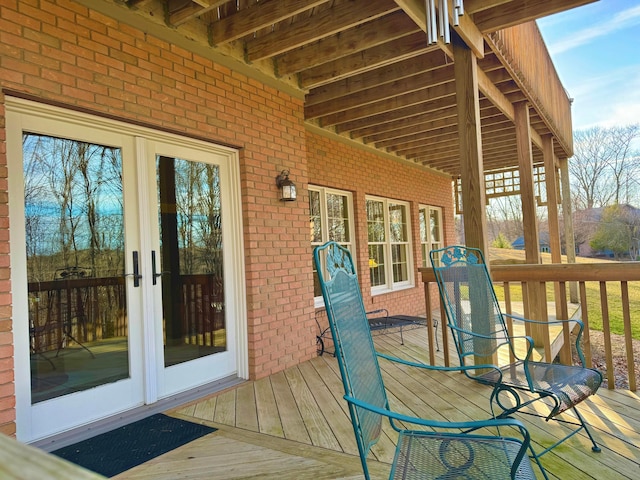 wooden deck with outdoor dining area and french doors