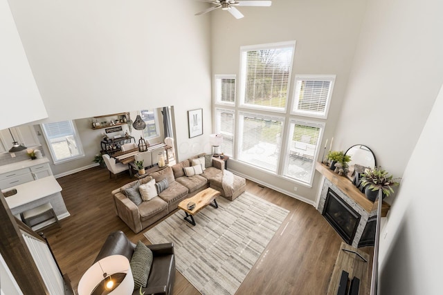 205 Partridge Ct, Pickerington, OH 43147 - living room with a glass covered fireplace, a high ceiling, ceiling fan, and wood finished floors
