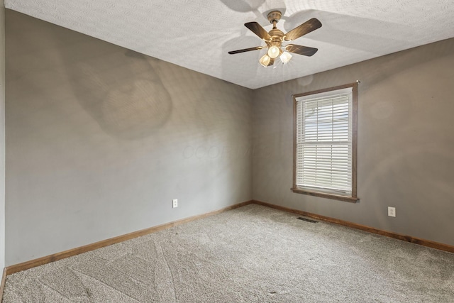 spare room featuring visible vents, baseboards, and carpet floors