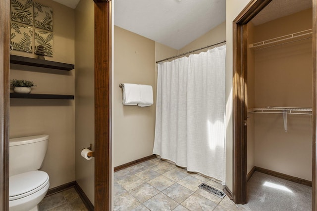 full bathroom with visible vents, baseboards, toilet, a spacious closet, and a shower with shower curtain