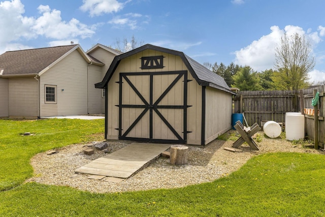 view of shed featuring fence