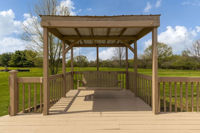 wooden deck featuring a lawn