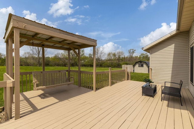 deck with a lawn, an outdoor structure, and a storage shed
