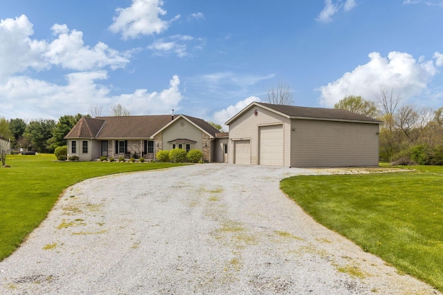 single story home with an outdoor structure, a front lawn, and driveway
