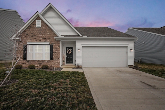 traditional-style house with brick siding, an attached garage, a shingled roof, and driveway