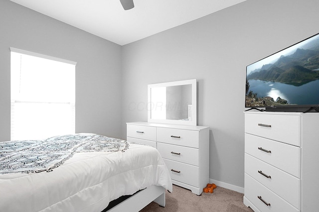 bedroom with baseboards, light colored carpet, and a ceiling fan