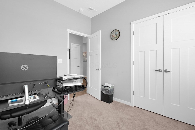 carpeted office space with visible vents and baseboards