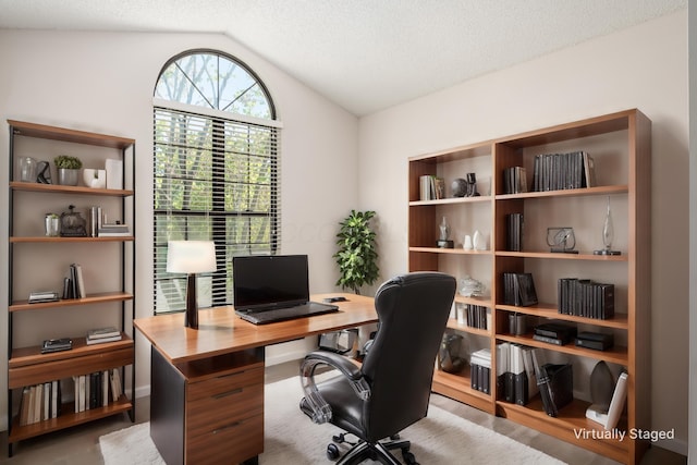office space featuring vaulted ceiling and a textured ceiling