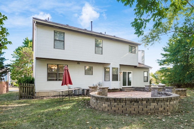 back of house featuring central AC unit, fence, a patio area, and a yard