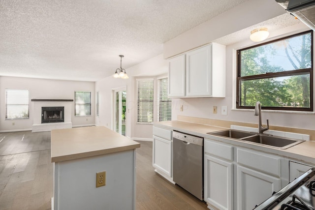 kitchen with a center island, stainless steel dishwasher, a sink, dark wood-style floors, and white cabinets