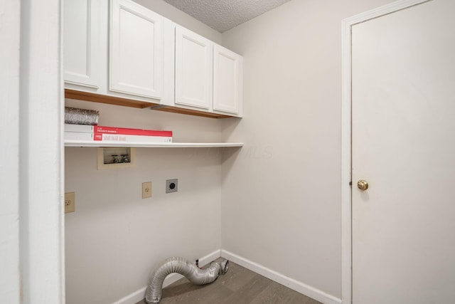 washroom featuring hookup for a washing machine, baseboards, wood finished floors, electric dryer hookup, and cabinet space