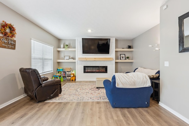 268 Aaron Dr, Delaware, OH 43015 - living room featuring baseboards, a fireplace, and wood finished floors