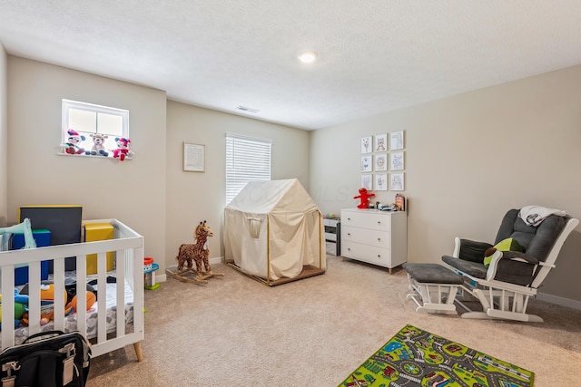 268 Aaron Dr, Delaware, OH 43015 - bedroom featuring carpet, baseboards, a textured ceiling, visible vents, and a crib