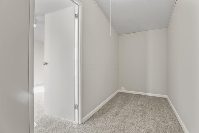 interior space featuring carpet flooring and baseboards