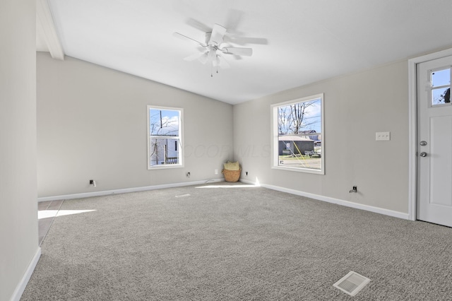 interior space with baseboards, a healthy amount of sunlight, visible vents, and ceiling fan