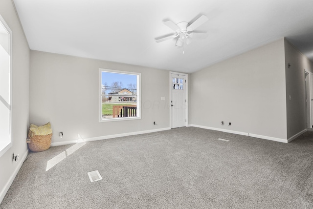 spare room featuring baseboards, carpet, and a ceiling fan