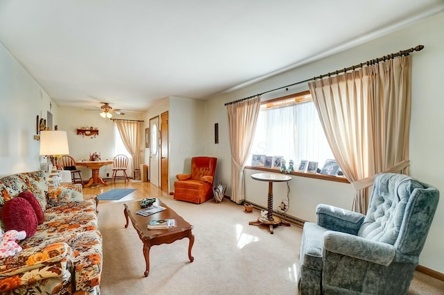 carpeted living room with a ceiling fan