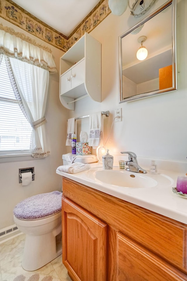 bathroom featuring vanity, toilet, and visible vents