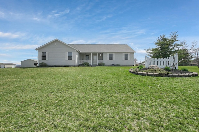 view of front of house featuring covered porch, fence, and a front yard