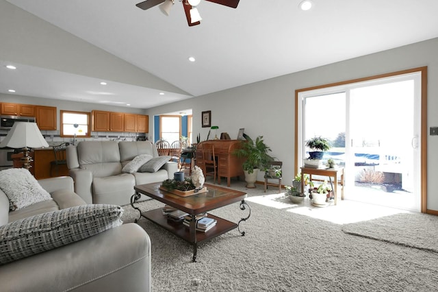 carpeted living room featuring a ceiling fan, lofted ceiling, and recessed lighting