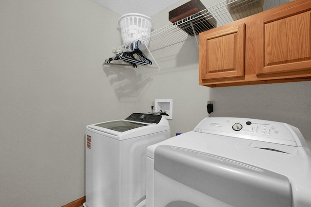 laundry room featuring cabinet space and washing machine and dryer