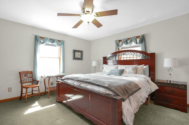 bedroom featuring light carpet, baseboards, multiple windows, and ceiling fan