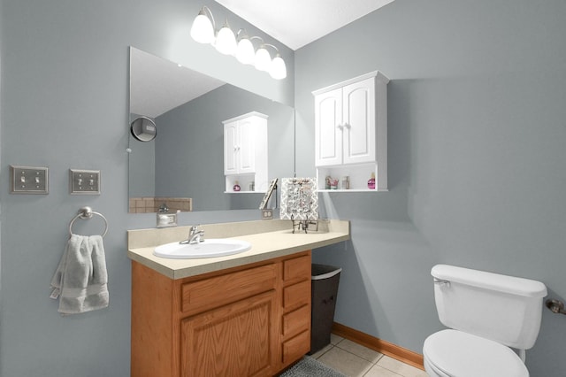 bathroom featuring baseboards, toilet, tile patterned flooring, and vanity