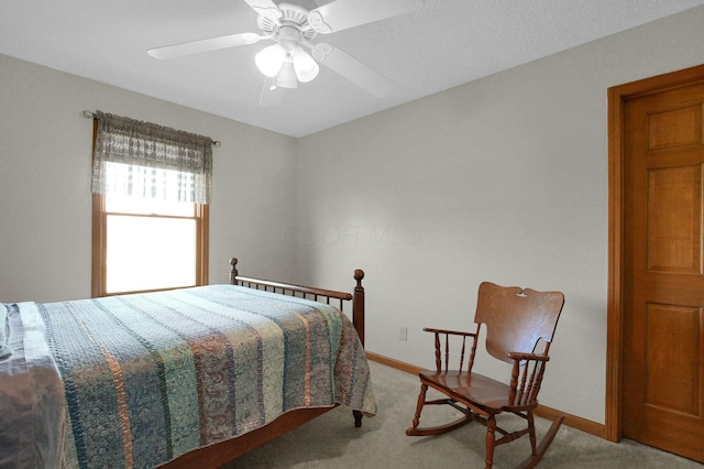 carpeted bedroom featuring baseboards and a ceiling fan