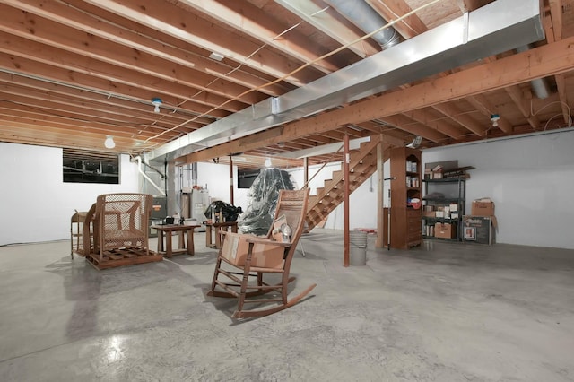 unfinished basement featuring water heater, heating unit, and stairway