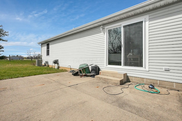 view of property exterior with a patio and a yard