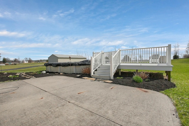 view of property's community with a yard, a deck, and a patio area