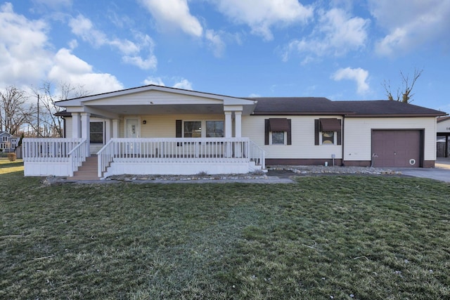 view of front of house with a garage, driveway, a porch, and a front lawn
