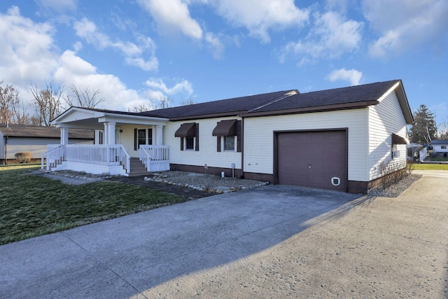 ranch-style home featuring aphalt driveway, covered porch, a front yard, and a garage