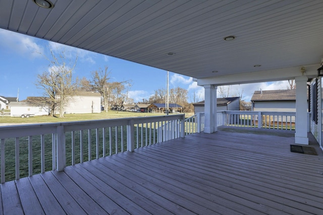 deck with an outbuilding, a yard, and a residential view