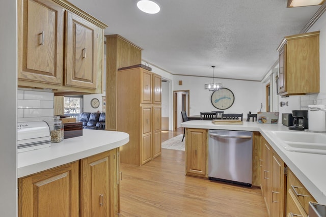 kitchen featuring tasteful backsplash, light wood-type flooring, a peninsula, stainless steel dishwasher, and a sink