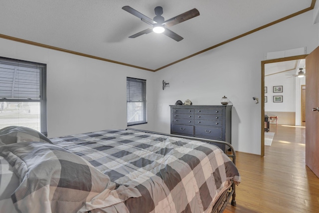 bedroom featuring wood finished floors, a ceiling fan, and ornamental molding